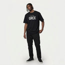 Person wearing a black t-shirt with 'GRCE' text on a white background