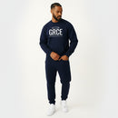 Man wearing a navy blue sweatshirt and pants with 'GRCE' logo on a white background