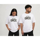 Two people wearing white t-shirts with 'GRCE' printed on them against a plain background.