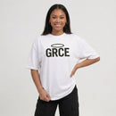 Person wearing a white t-shirt with 'GRCE' printed on it against a plain background
