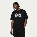 Person wearing a black t-shirt with 'GRCE' logo on a white background