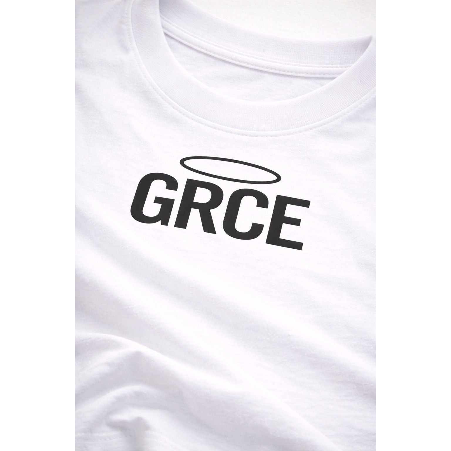 White t-shirt with 'GRCE' printed on it, featuring a black halo symbol above the text.