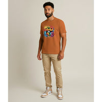 Man wearing a brown t-shirt with 'God is Love' text on a beige background