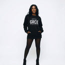 Person wearing a black sweatshirt with 'GRCE' text on a white background