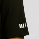 Black t-shirt sleeve with a white logo on a light gray background